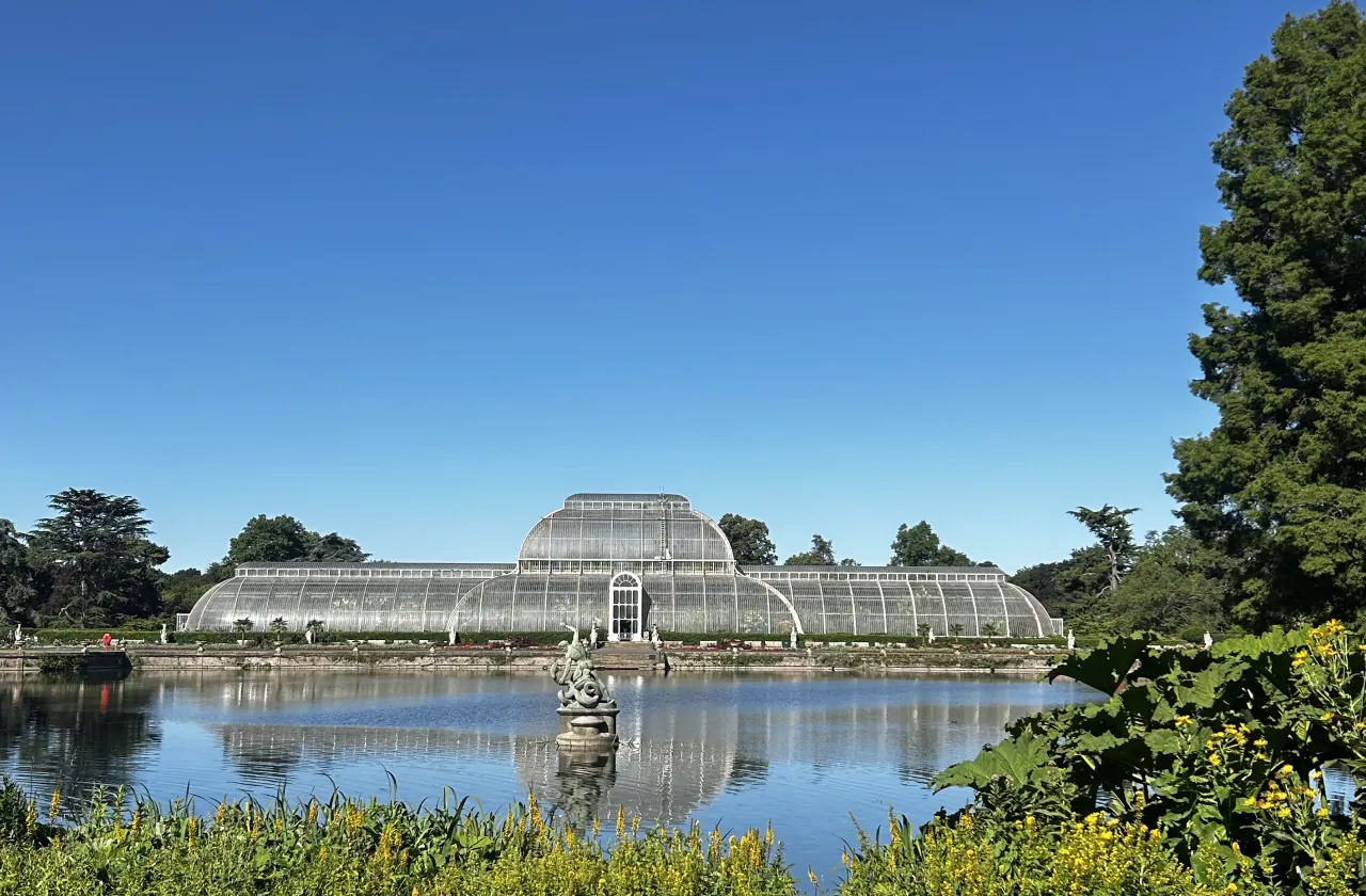 glass conservatory in front of pond.