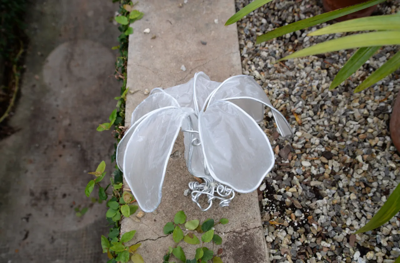 Big paper flower on cement wall.