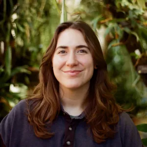 Person with light brown shoulder length hair, fair skin and brown eyes. 