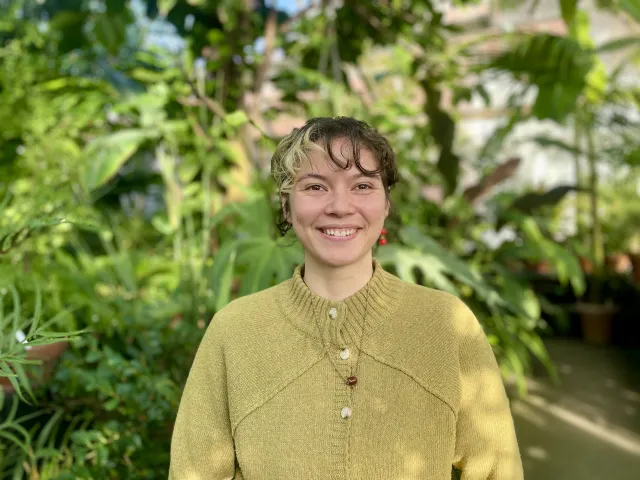 Portrait of woman with brown and blonde hair and a yellow sweater.