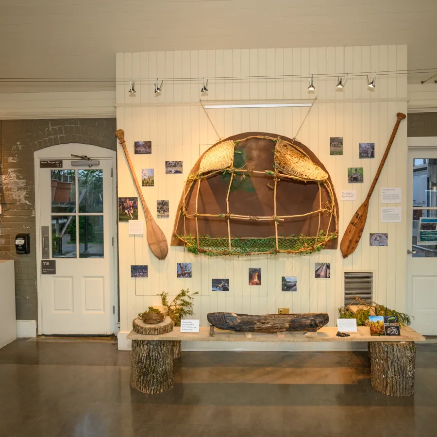 mini mishoon and mini wetu on display with photos