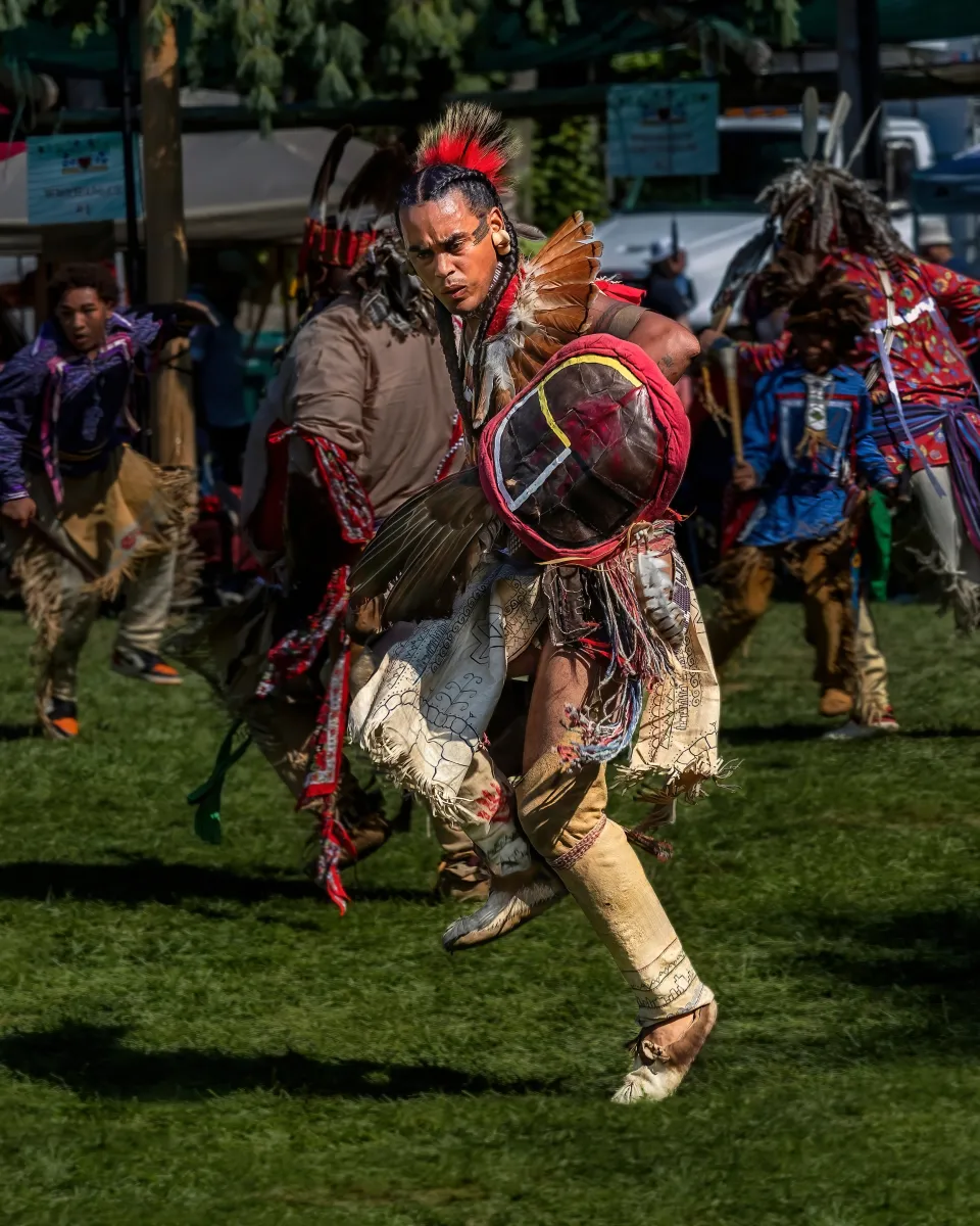 Man in traditional indigenous clothing dancing 