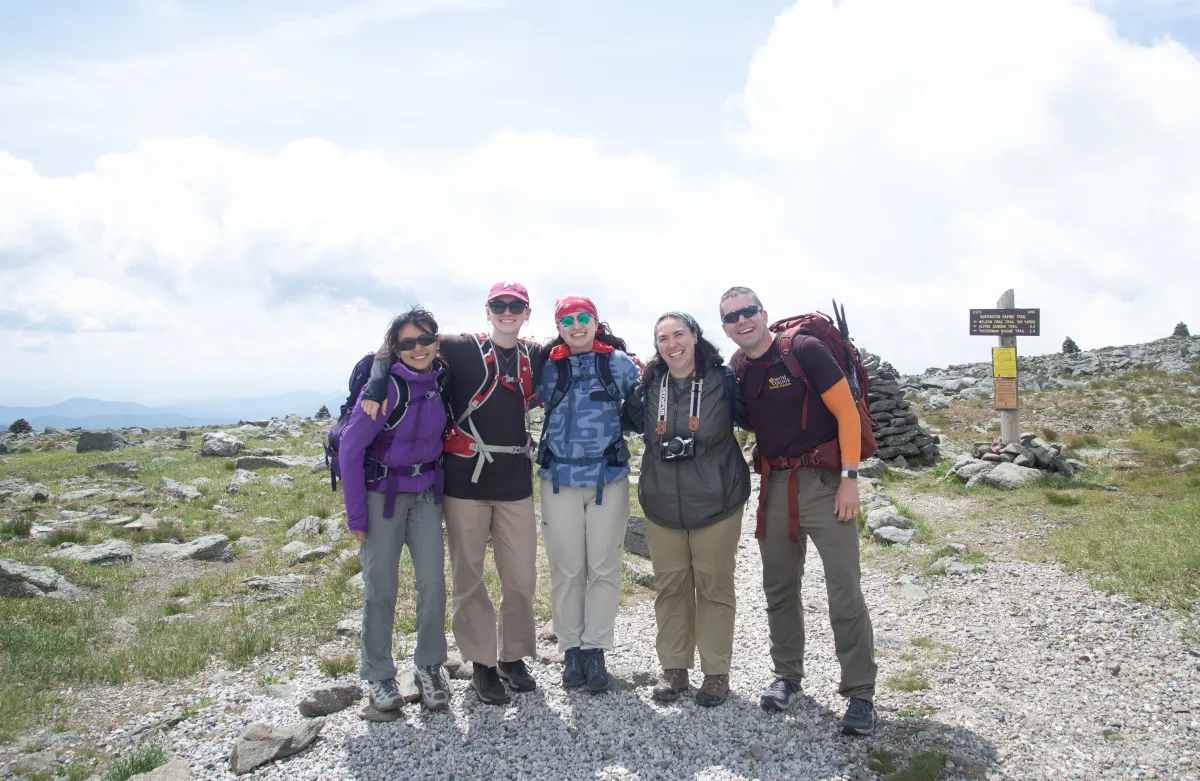 Group of hikers at the summit of Mount Washington.